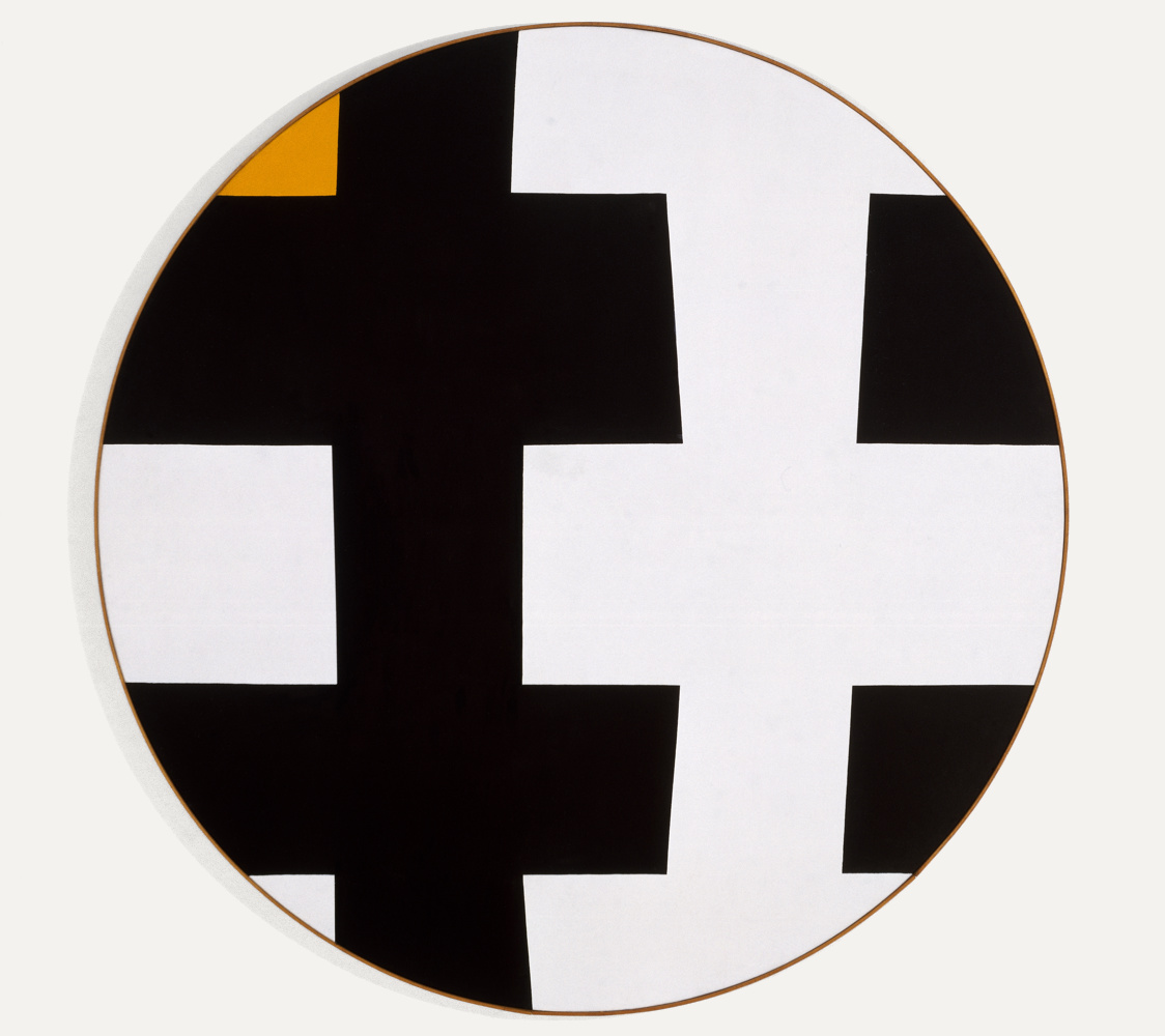 Circular Tondo, black and white shape pattern fitting together cropped tight by the circle one of the white edges is replaced with a deep yellow which verges on orange. The work has a very thin wood frame which adds a bit of warmth to the work.