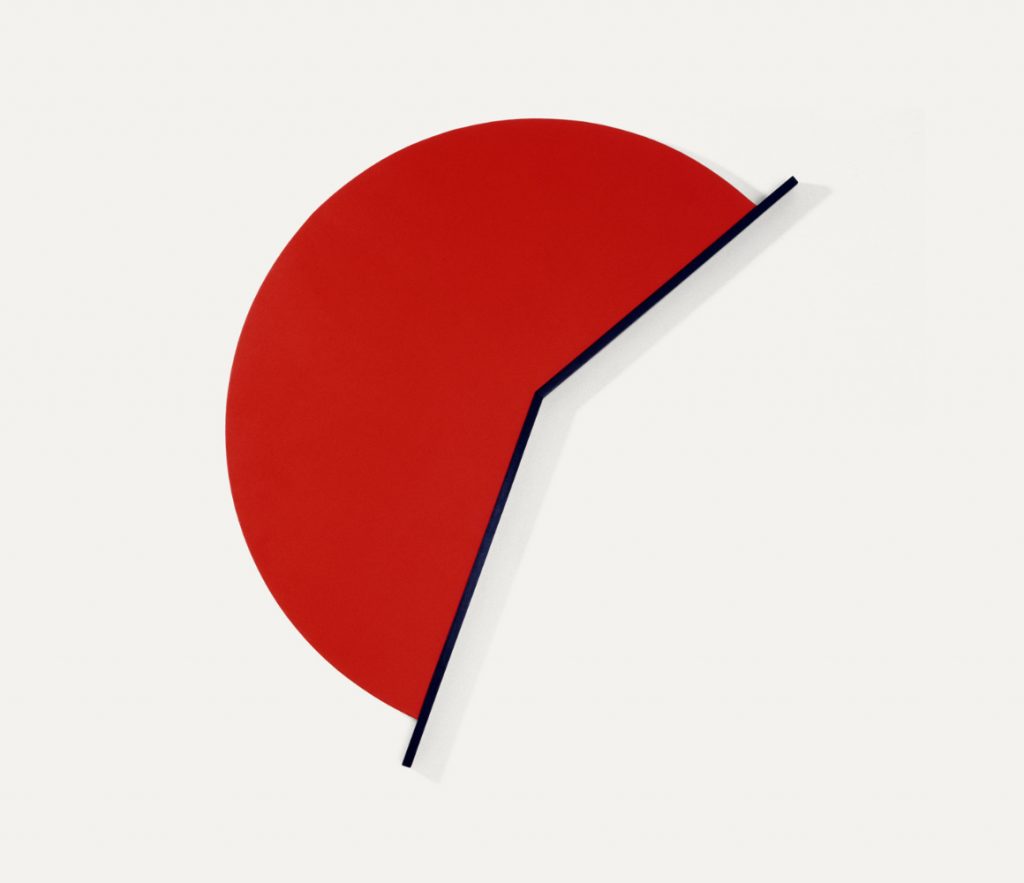 Roughly half of a bright red circle, intersected by two thick black lines, looking like an analog clock with the hands at 1:35. The rest of the circle is missing giving the feeling of negative space.