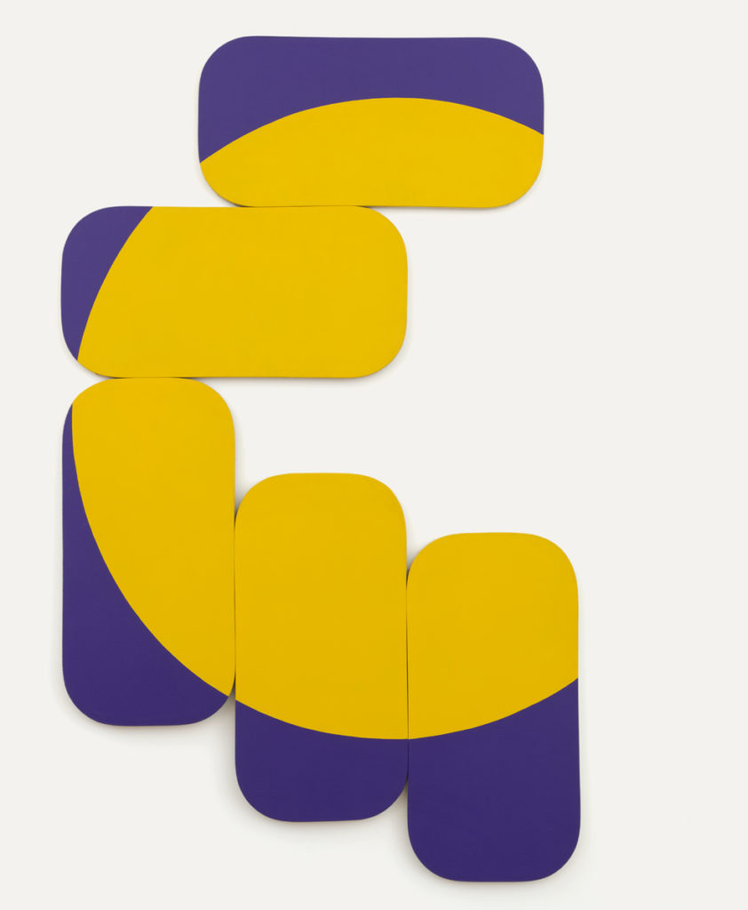 Constellation Yellow - Blue Violet by Leon Polk Smith is an arrangement of 5 rounded rectangular canvases, partially yellow, partially violet/blue, fitted together to create the left side of a yellow circle. The bottom three canvases are rotated to be tall while the top two are wide.