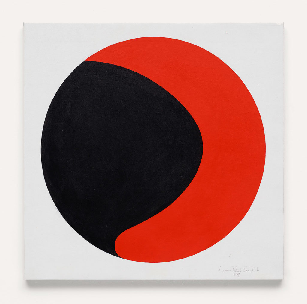 Square white canvas, with a circular painting inside of it, the circle contains a black shape surrounded by a bright red amorphous shape