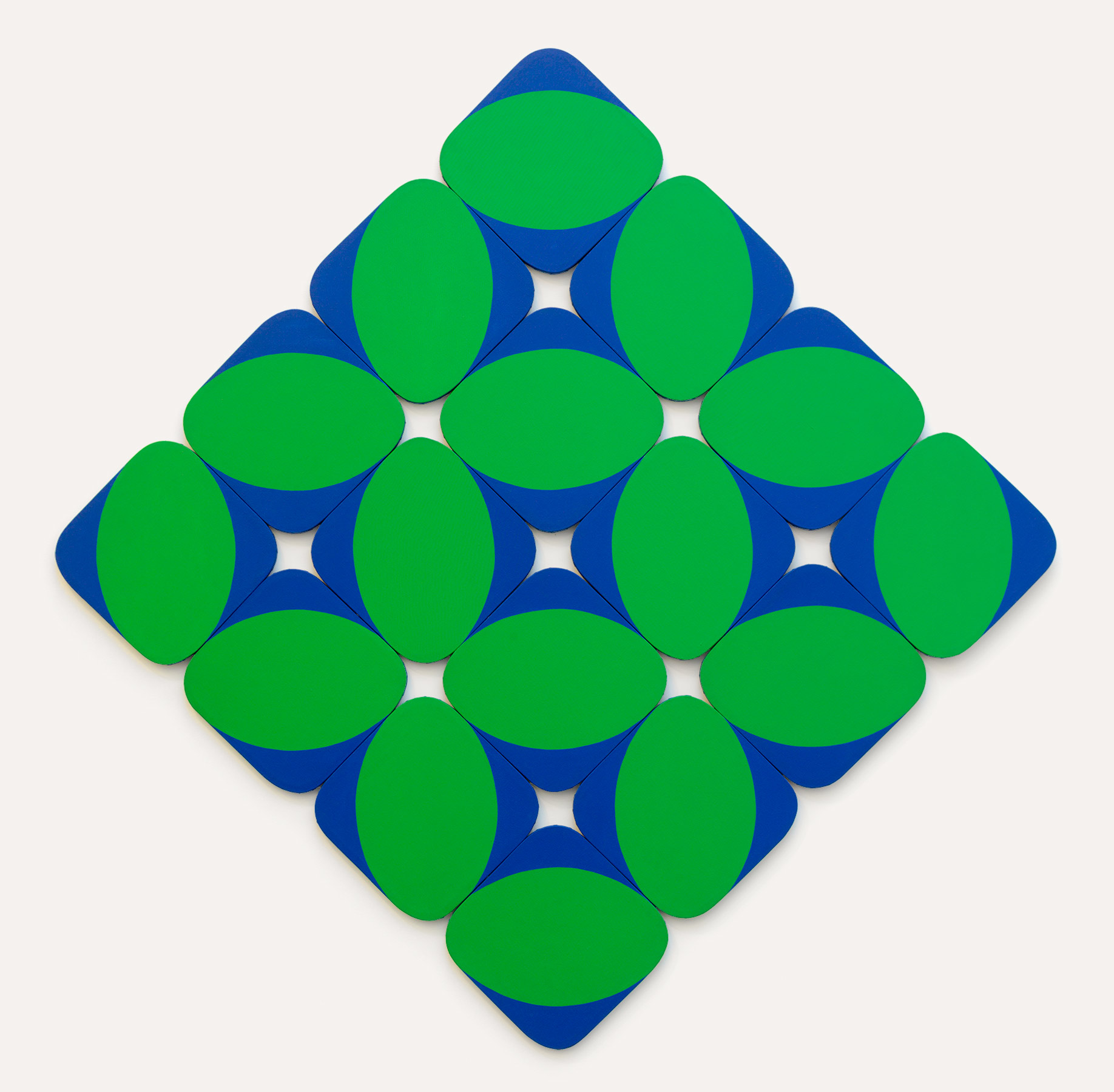 16 rounded corner diamond-shaped canvases, fit together 4x4 to make one large diamond shape for the entire piece. Each has a green pill shape either horizontal or vertical and blue cuts filling in the rest of the canvases. The alternation of position and arrangement create a complex pattern which also gains complexity from the shapes cut-out where rounded corners meet.