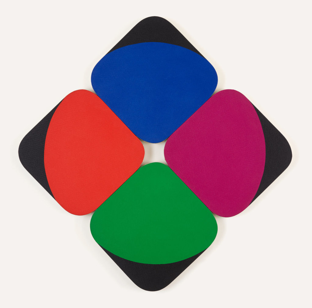 Four rounded square shapes turned in a diamond formation 2x2 to make a larger diamond. There is no space between the canvases, so center where they meet creates a shape from the negative space. Each is a rich color, primary blue, green, red, and also a violet color, each has a black tip painted on the outer edge