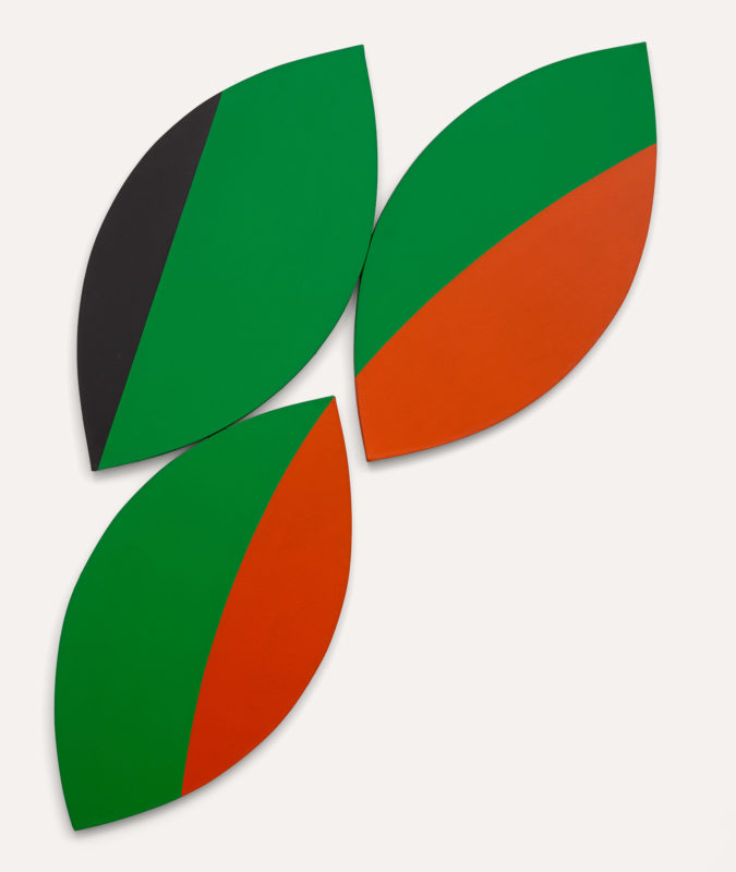 Sharp leaf-shaped canvases, mainly green, arranged to be pointing towards the upper left. The upper left movement is accentuated by the cut of black in the left canvas and the cuts of reddish orange on the right canvases.