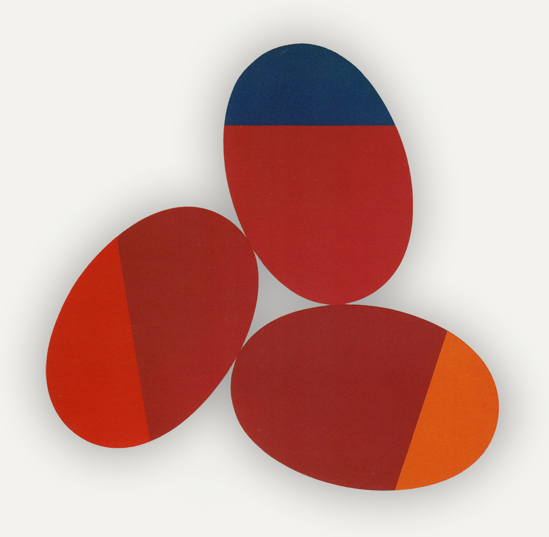 The artwork Constellation M by Leon Polk Smith is comprised fo three oval canvases arranged in a way that feels like they are each lookin in on one another. The circles have a straight line splitting a third of them giving each an accent color, one is a brighter red than the red of the canvas, the other is a dark blue and the the third a golden color verging on orange. The three canvases touch each other in a way that they create a negative space where they meet that draws your eye towards the center of the work while at the same time, the accent colors are positioned at the far edges of the ovals drawing your eye in an outward motion. The eye can also see the base red color in the canvas as a larger shape that is overlapping everything like a large irregular upside-down triangle.